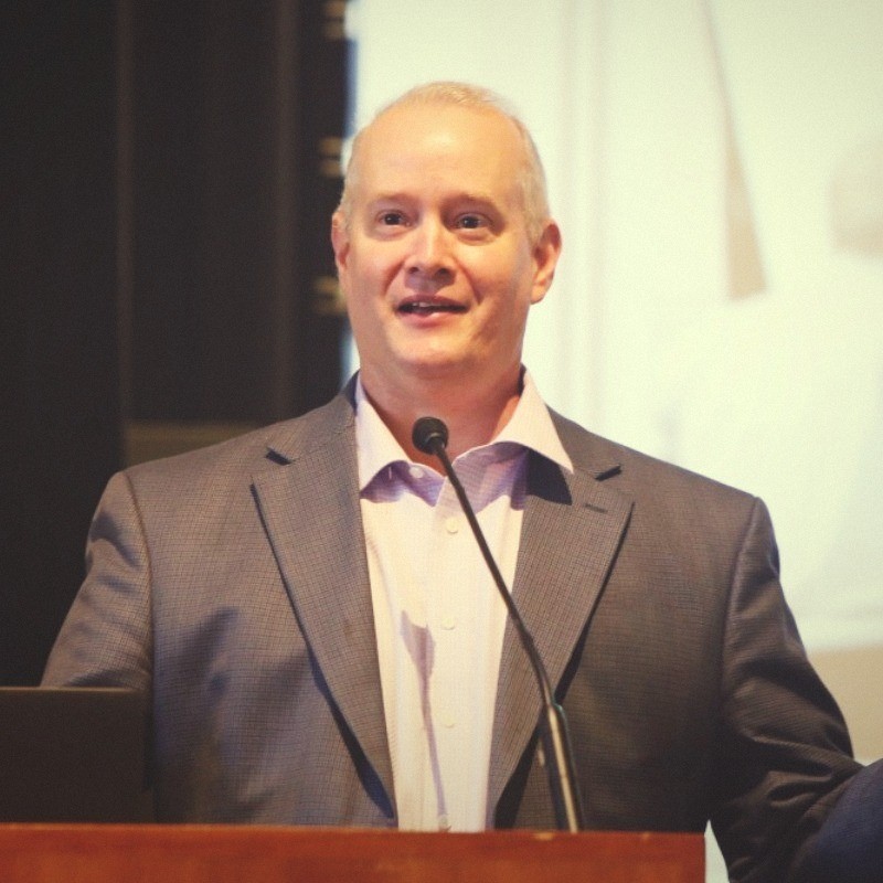 Jason Rupp speaking at a conference podium